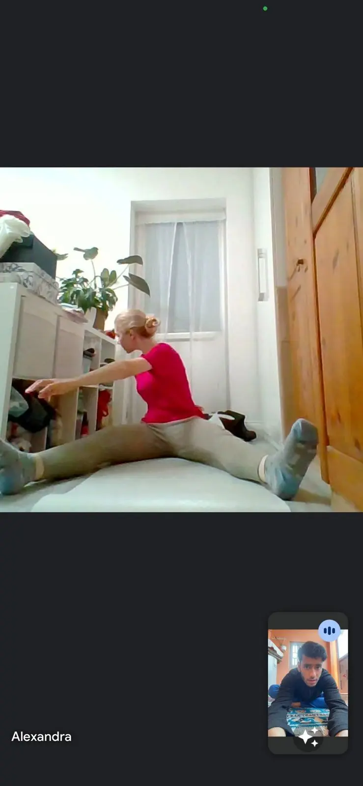 Instructor assisting a student in deep stretch